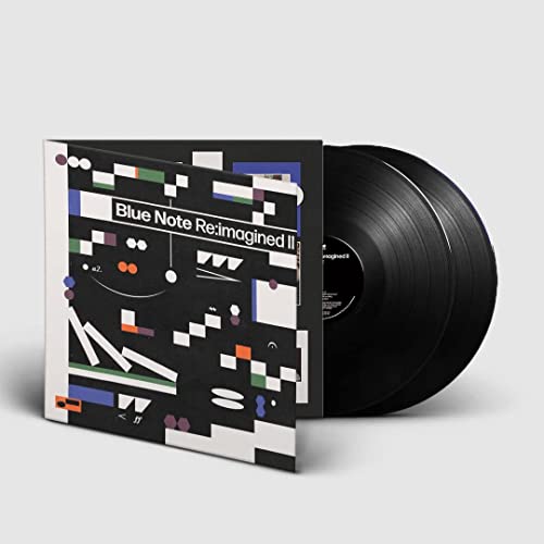 Vinyl record with colorful, geometric album art leaning against it.