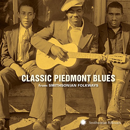"CD cover featuring sepia-toned image of three men, one playing guitar."