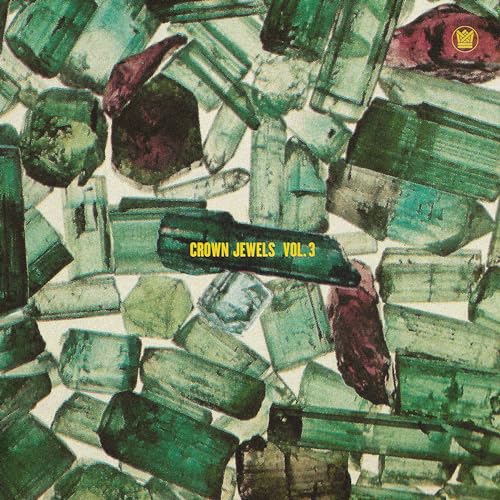 Album cover featuring a pile of green and red gemstones with text.