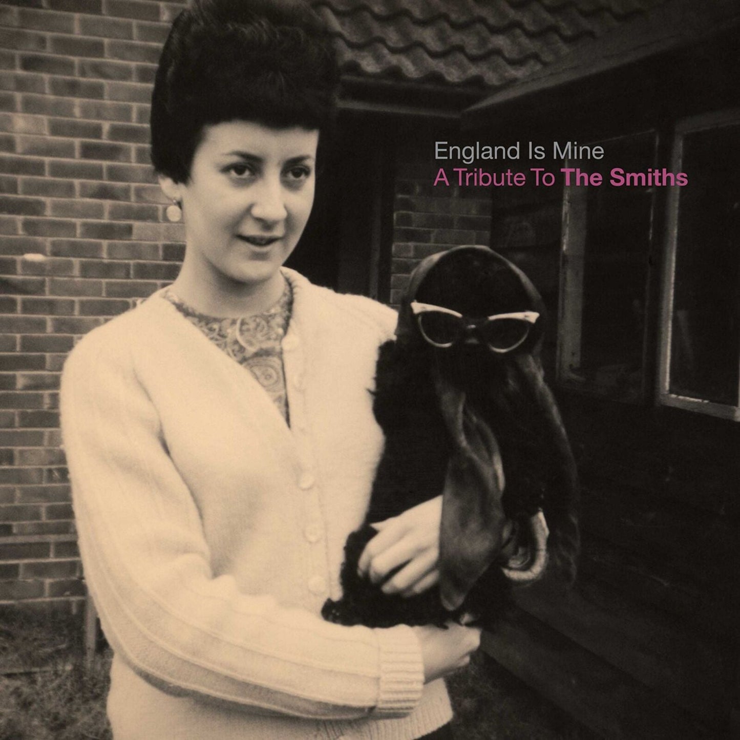 Black and white album cover featuring a woman holding a goat wearing sunglasses.