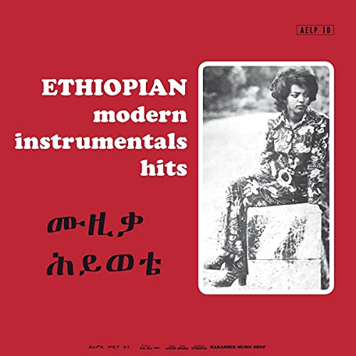 Red album cover with a portrait of a man in patterned clothing.