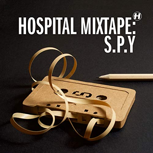 Cardboard cassette tape with unspooled ribbon and a pencil on a black background.