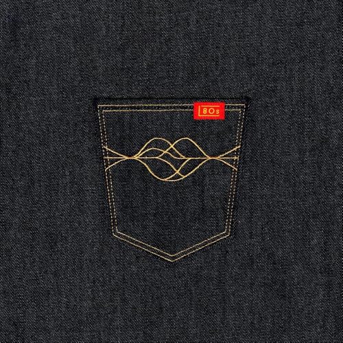 Close-up of a dark denim pocket with gold stitching and a red 80s tag.
