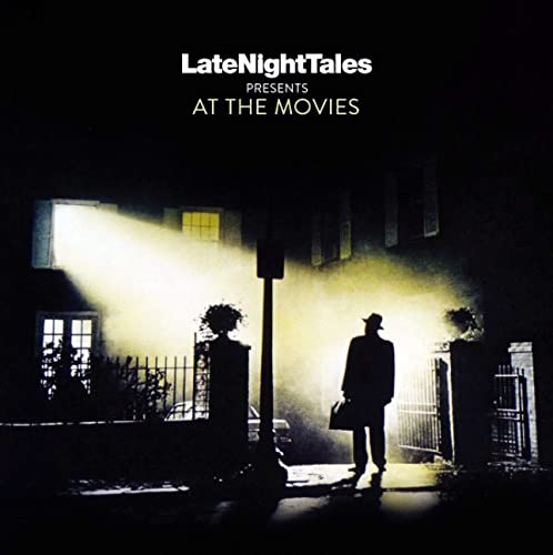 Dark album cover with a silhouetted figure standing in front of a house.