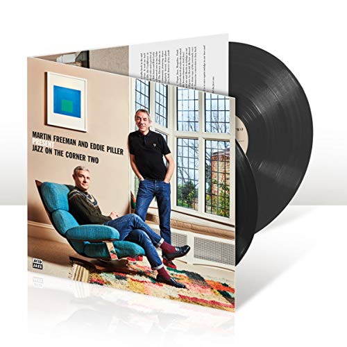 Vinyl record with cover featuring two men and a blue armchair.