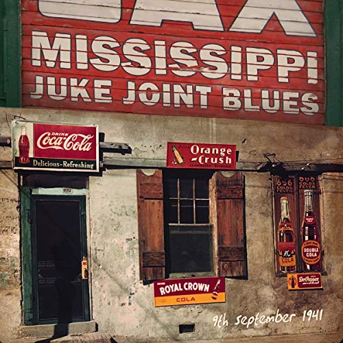 Vintage storefront with "Mississippi Juke Joint Blues" sign and Coca-Cola ads.