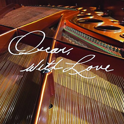"Image of a grand piano's interior with 'Oscar, With Love' written in white cursive text."