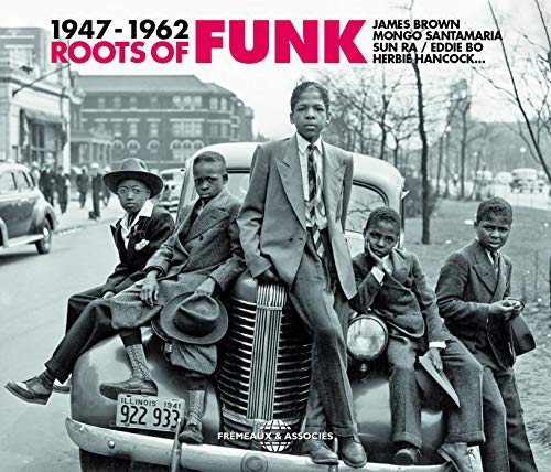 Black and white photo of young men posing on a vintage car; album cover.