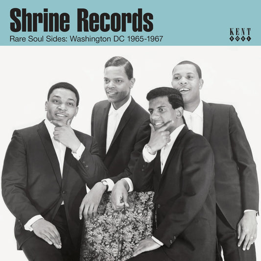 Black and white photo of four men in suits posing for a music album cover.