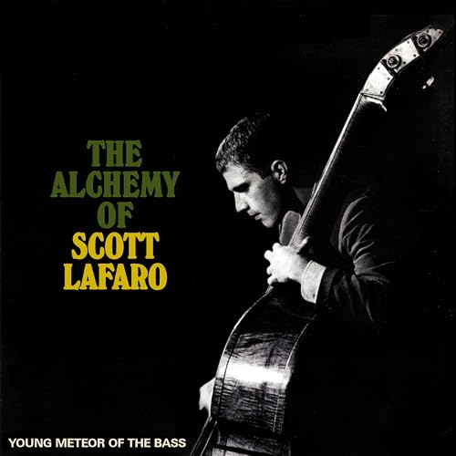 Black and white photo of Scott LaFaro playing an upright bass against black background.