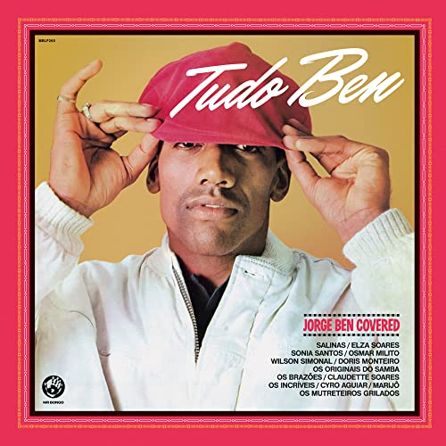 CD cover for "Tudo Ben," featuring a man in a red cap and jacket.