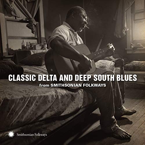 CD cover featuring a Black man playing guitar in a room.