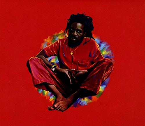 Album cover of "We Remember Dennis Brown" featuring a man in red against a colorful background.