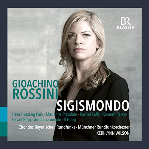 CD cover featuring a woman with blonde hair, wearing a black top, against a grey background.
