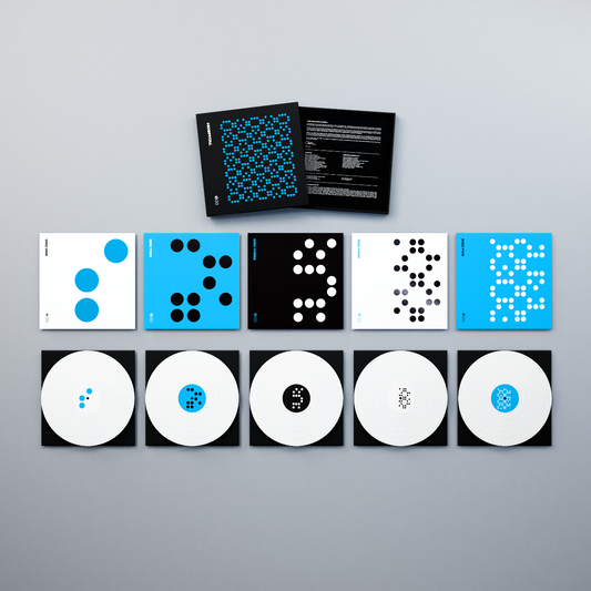 Six white vinyl LPs and two booklets with blue and white dot patterns.