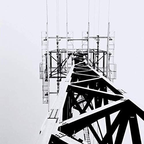 Black and white photo of a tall, industrial metal transmission tower.