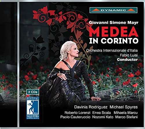 CD cover featuring a woman in a black gown sitting among red flowers.