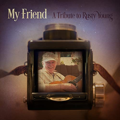 CD cover: vintage camera displaying a man with a guitar.