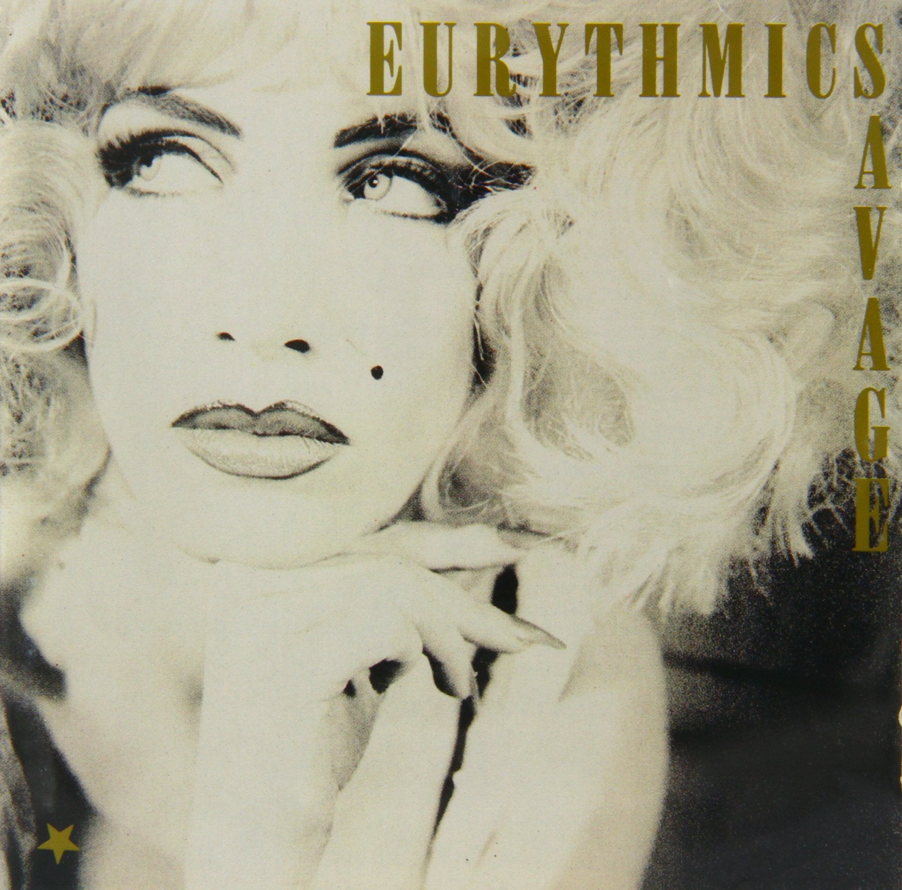 Close-up black and white portrait of Annie Lennox with gold text Eurythmics Savage.
