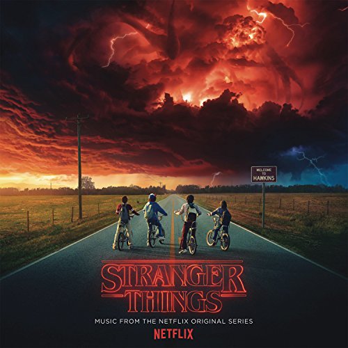 Four children ride bicycles down a road toward a dark, stormy, red-lit sky.