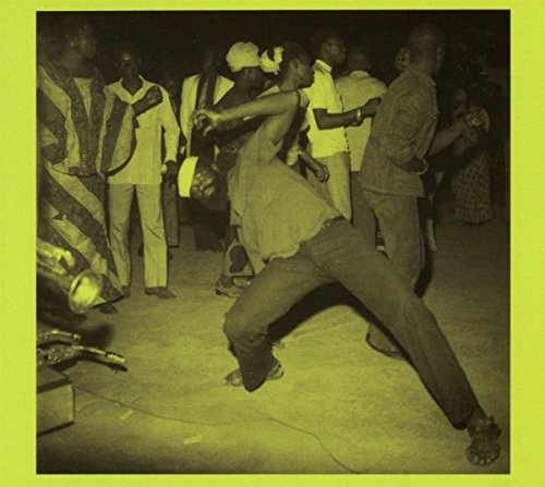 Vintage photo of people dancing at an outdoor event in Burkina Faso.