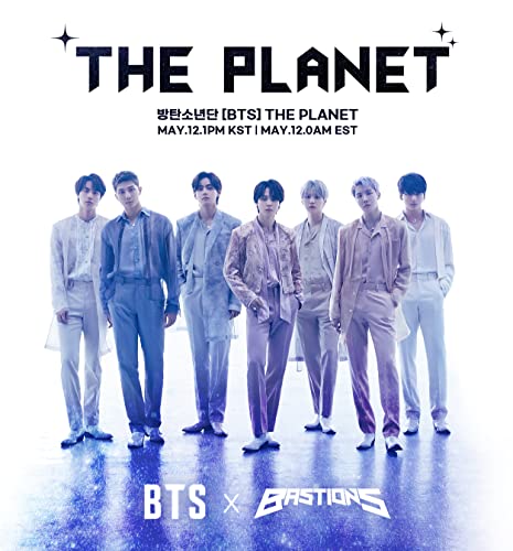 The seven members of BTS standing together in light-colored suits against a blue background.