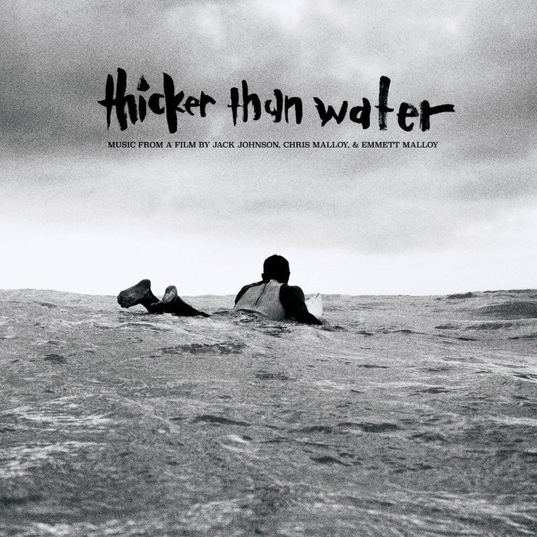 Black and white album cover with a person lying on ocean waves.