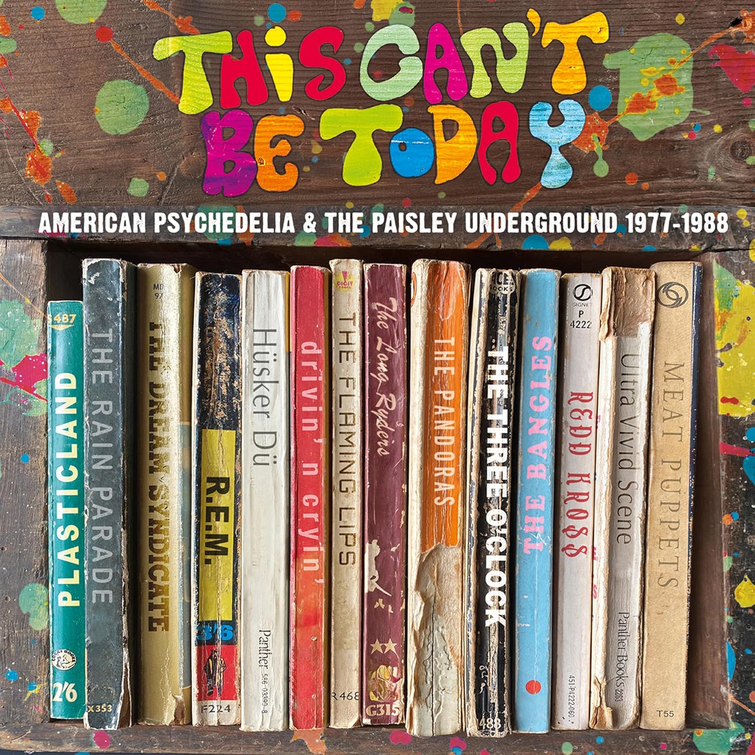 Album cover showing a row of vintage book spines against a paint-splattered wooden background.
