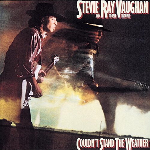 Stevie Ray Vaughan playing guitar in front of a tornado on a dark background.
