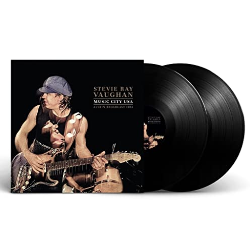 Stevie Ray Vaughan album cover and two black vinyl records.