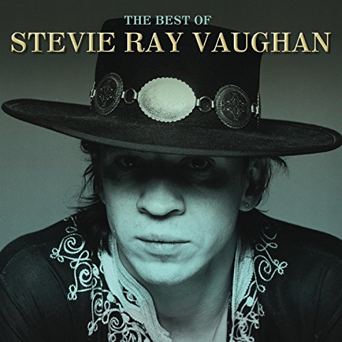 Stevie Ray Vaughan in a hat, portrait album cover, dark tones.