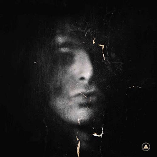Dark, textured portrait of a person with obscured features and gold cracks.