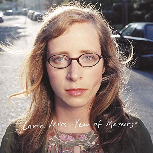 Laura Veirs' album cover featuring a woman with glasses and flowing hair.