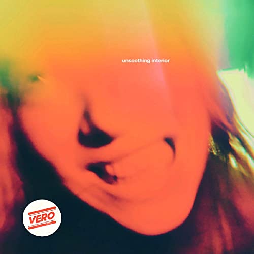 Blurred, colorful portrait with the text unsoothing interior and a Vero logo sticker.