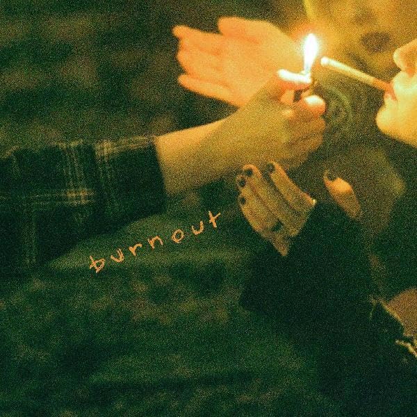 Hands lighting a cigarette, with the word "burnout" overlaid.