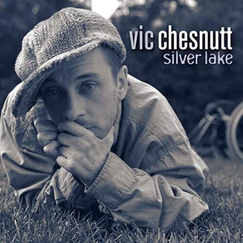 Vic Chesnutt album cover: man in cap resting chin on hands.