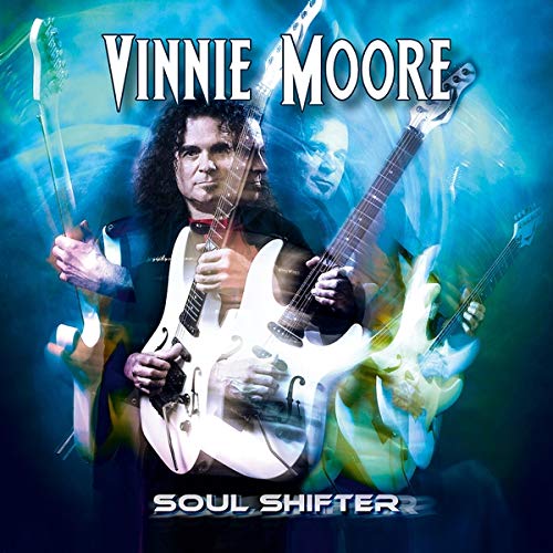 Vinnie Moore album cover, guitarist with electric guitars, blue and white effects.