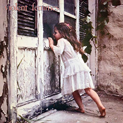CD cover: girl in white dress peering through weathered window.
