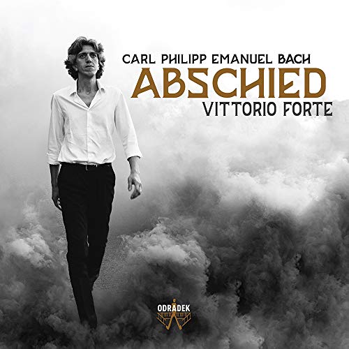 "Album cover featuring a man in a white shirt and black pants amidst fog."
