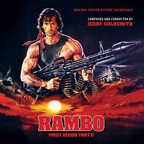 Rambo holding a machine gun against a sunset background with helicopters in the sky.