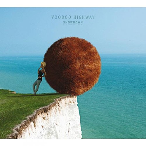 CD cover: woman near a large sphere on a white cliff.