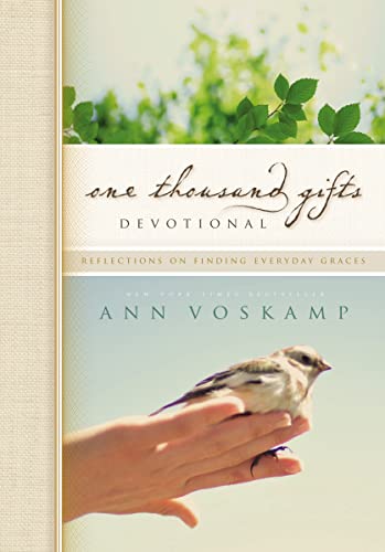 Book cover with bird in hand, foliage, and title "One Thousand Gifts Devotional".