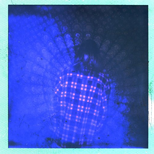 Blue-toned album cover featuring a blurred figure in plaid.