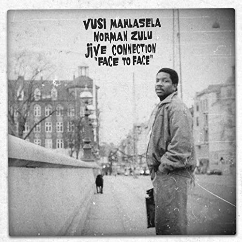 Black and white album cover featuring a man standing on a city street.