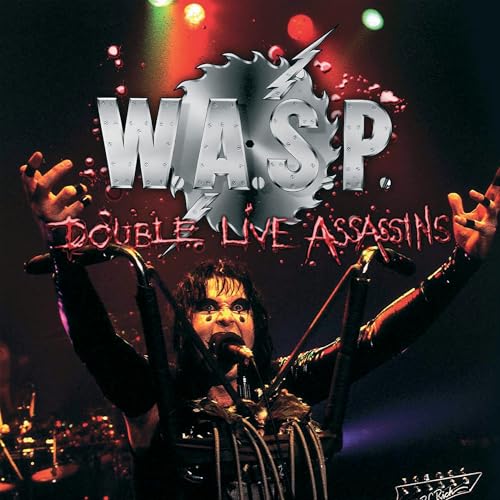 W.A.S.P. singer performing live with arms raised under the band logo and album title.