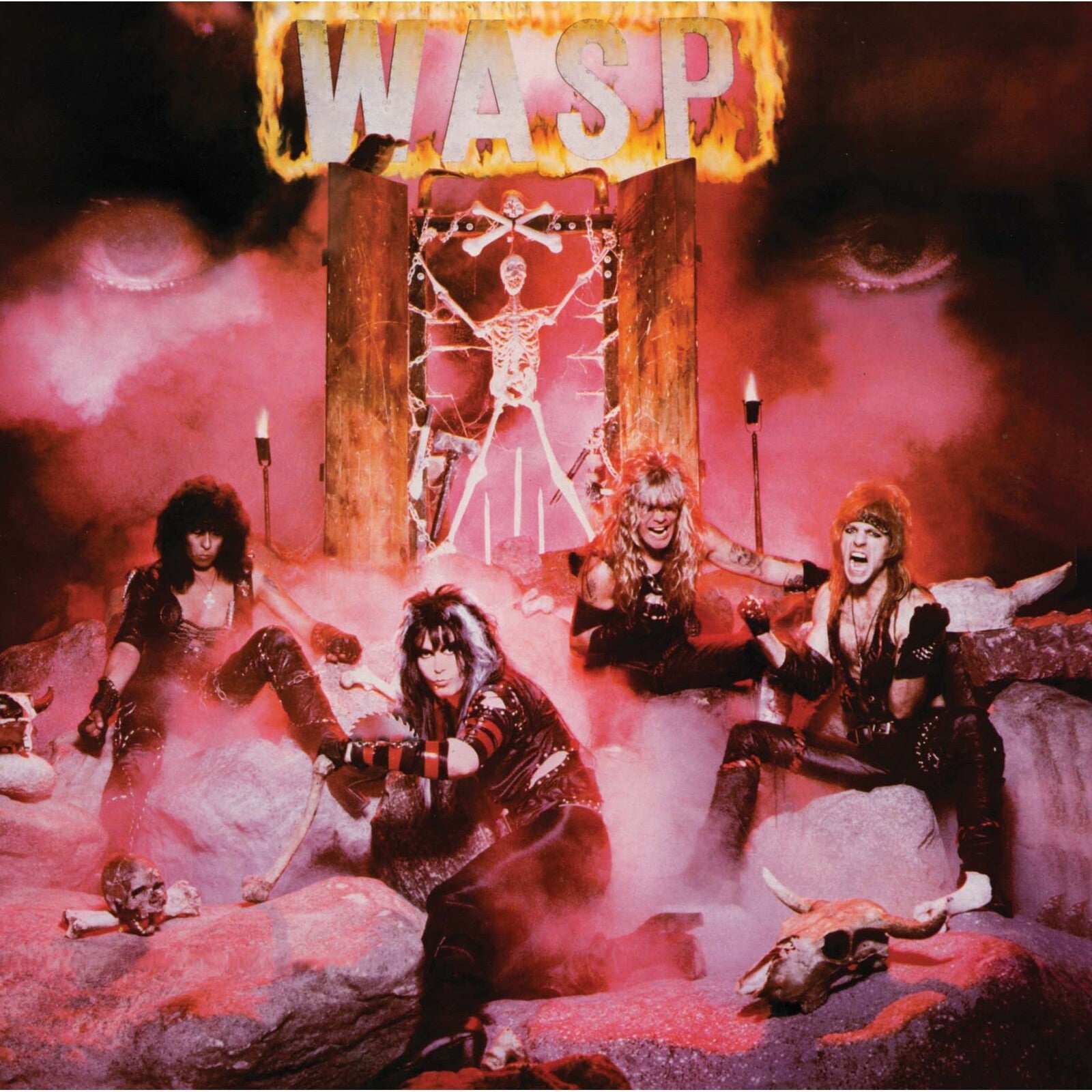 W.A.S.P. band members in leather and makeup posing in a red, smoky, skeletal setting.
