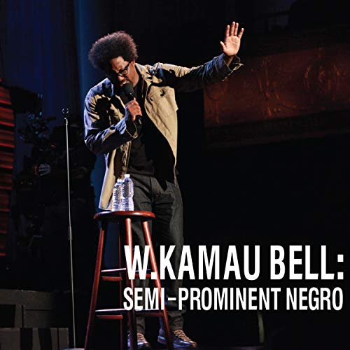 W. Kamau Bell on stage performing comedy, with album title overlayed.