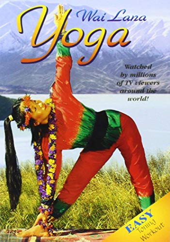 Woman in colorful outfit doing yoga pose in grass with mountains and lake background.