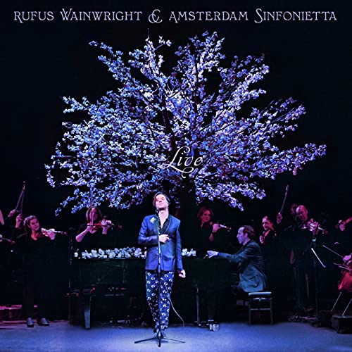 Rufus Wainwright performs with the Amsterdam Sinfonietta under a large illuminated cherry blossom tree.