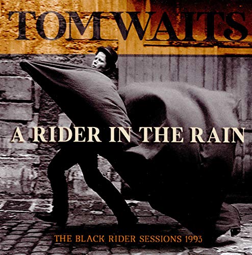 Tom Waits album cover: man with coat, elephant, brick wall backdrop.